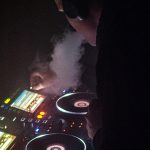 DJ vaping and mixing music in the dark